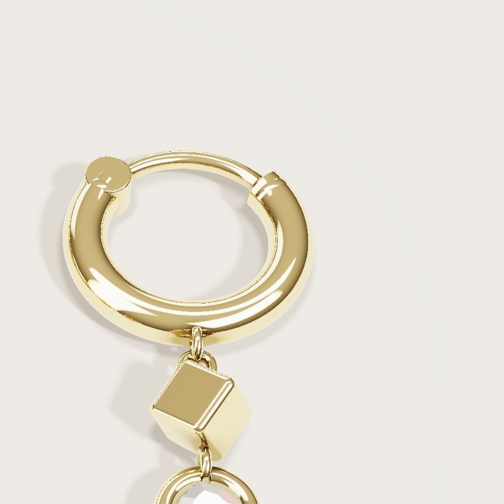 Close-up of the Prism Drop huggie earring in gold